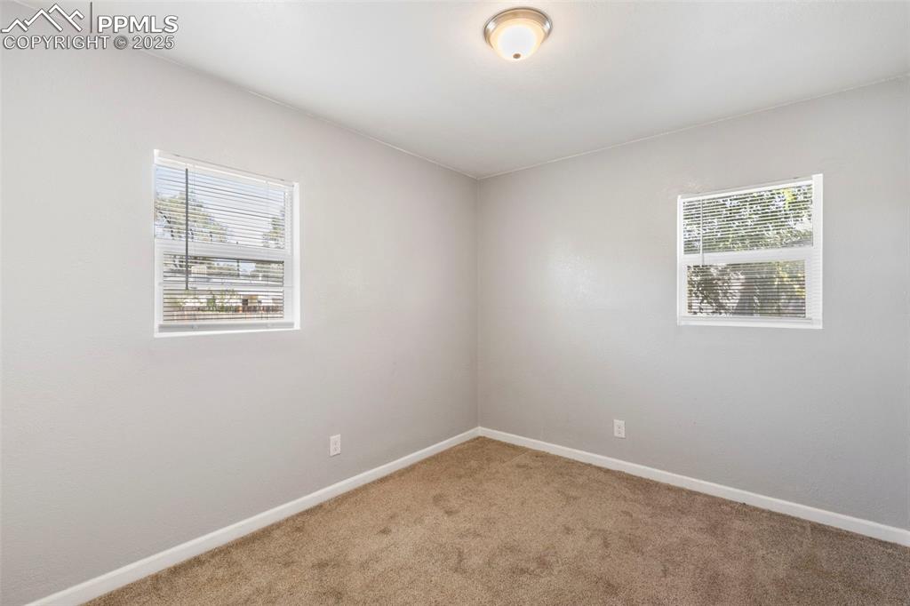 Room featuring carpet floors and baseboards