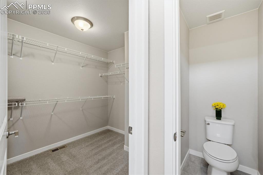 Primary Bedroom Walk In Closet + Toilet Room