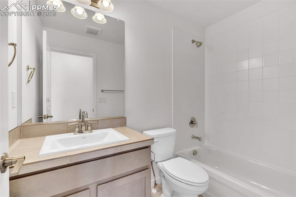 Full bathroom with washtub / shower combination and vanity