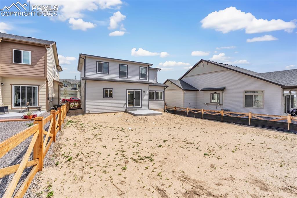 Rear view of property with a patio and a fenced backyard