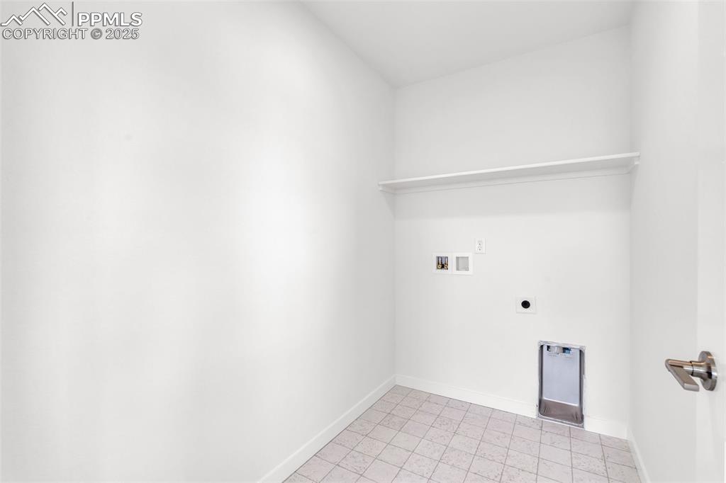 Washroom with washer hookup, electric dryer hookup, and light tile patterned flooring
