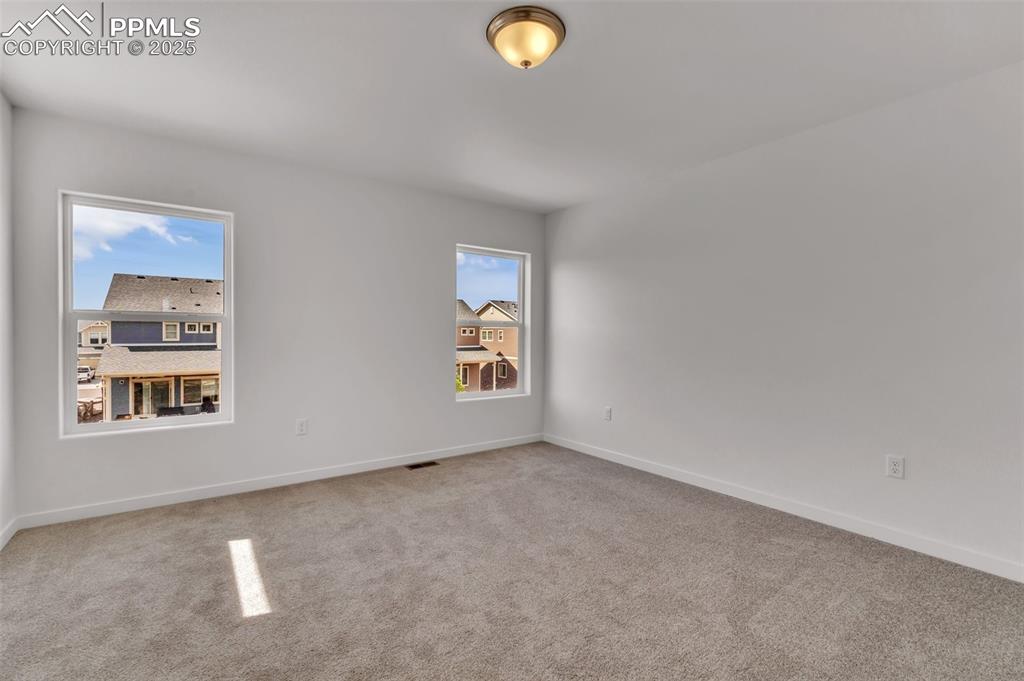 Carpeted empty room with baseboards