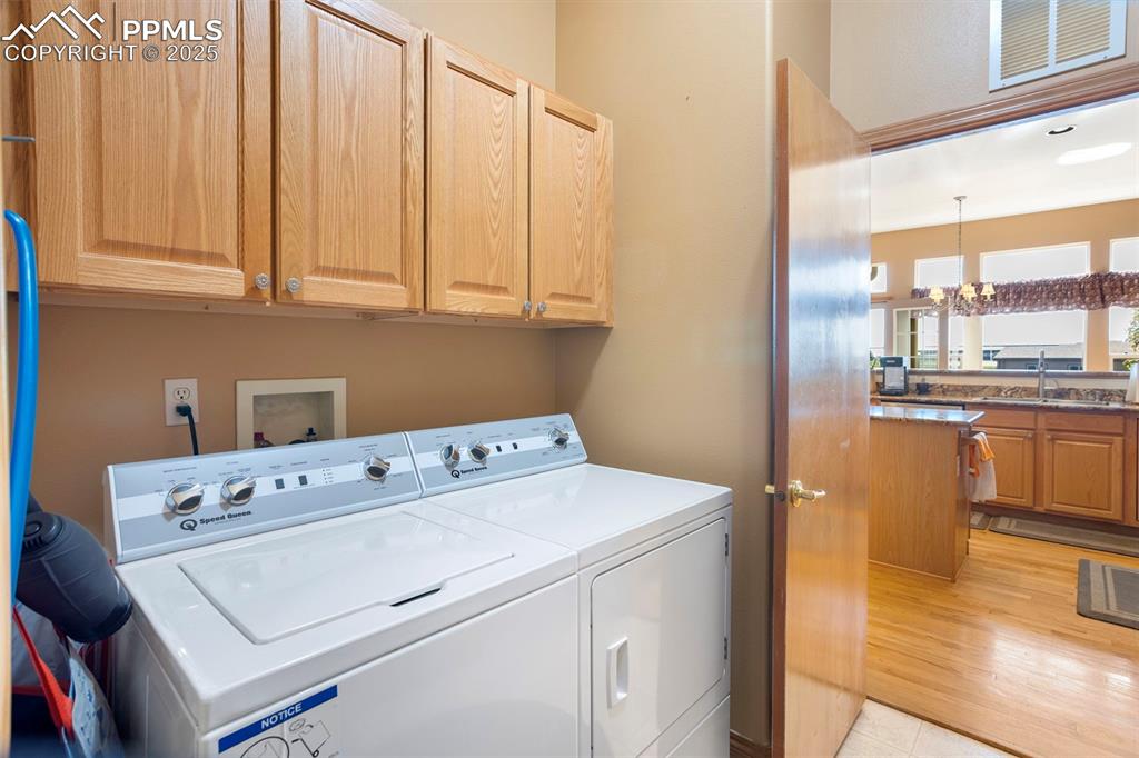 The man level laundry is located off the kitchen and leads to the garage. Washer/dryer stay.