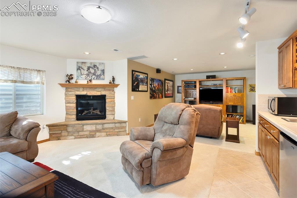 The huge basement family room is highlighted by a stone gas fireplace and wet bar.