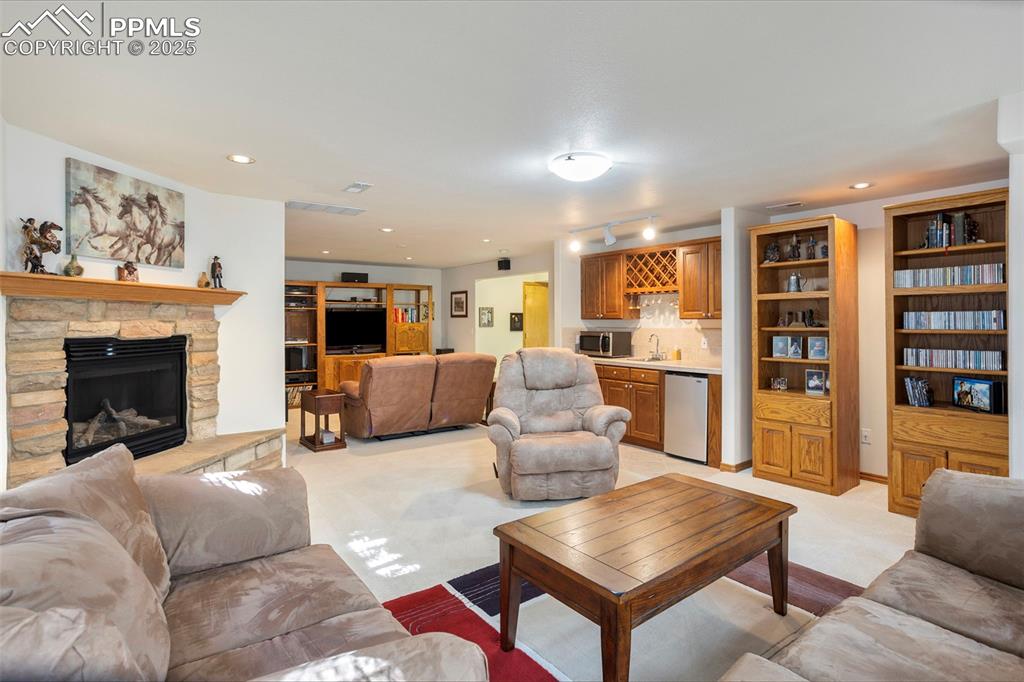 Basement family room includes a convenient wet bar with mini fridge.