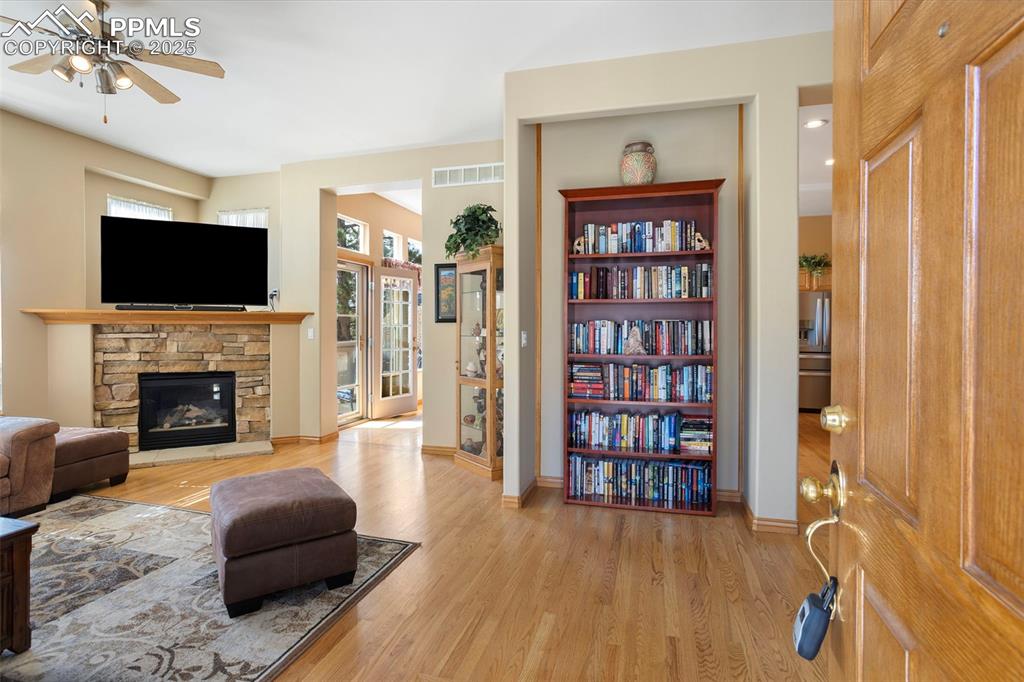 Upon entry, you are greeted with a view of the beautiful stone fireplace in the great room and the entry to the informal dining area where you can walk outside to the patio.