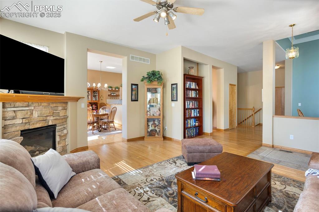 Main level great room grants entry to the informal dining area and the left side of the hallway accesses the kitchen, powder room and staircase to basement.