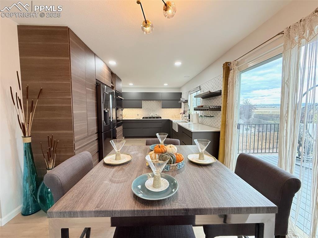 Dining room featuring light wood finished floors and recessed lighting