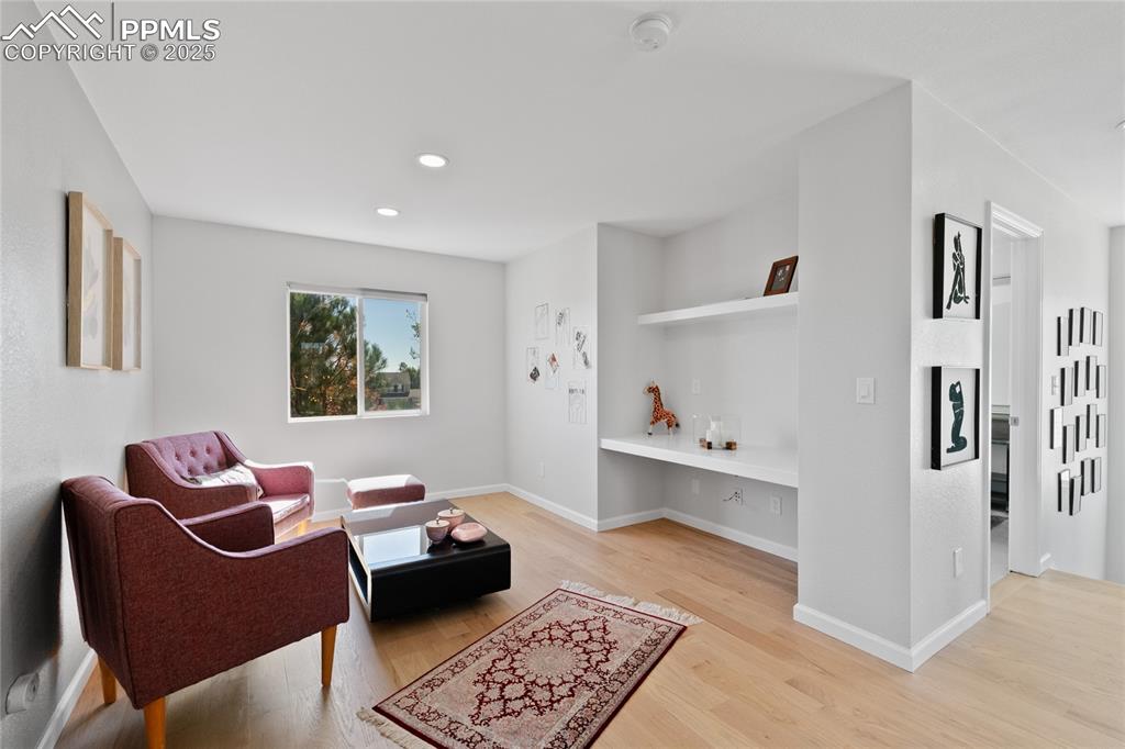 Sitting room featuring light wood finished floors and recessed lighting