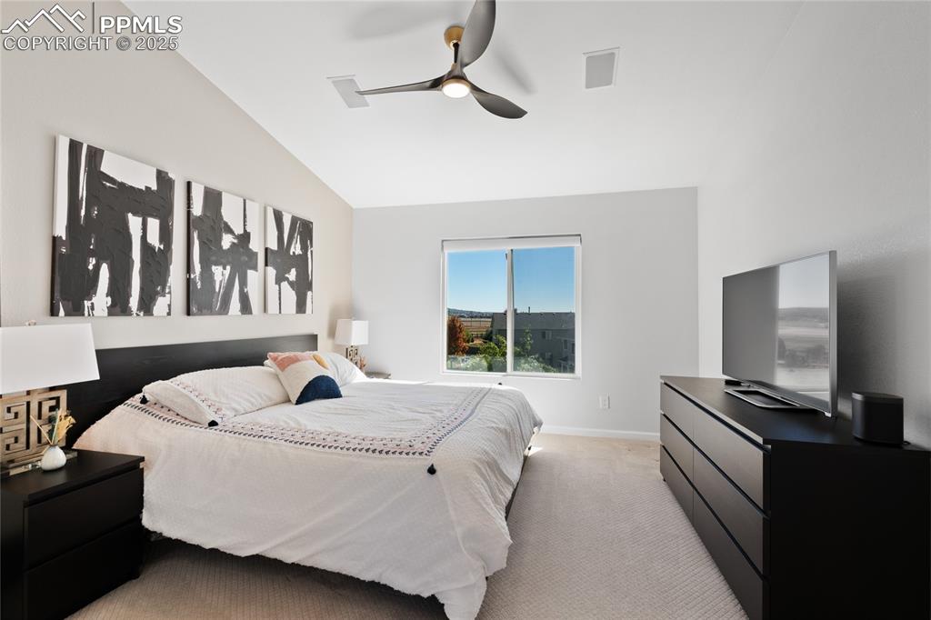Bedroom with carpet, lofted ceiling, and a ceiling fan