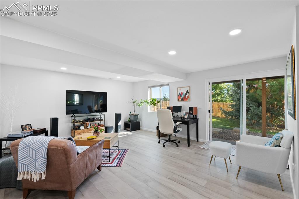 Living room featuring an office area, recessed lighting, and light wood-style floors