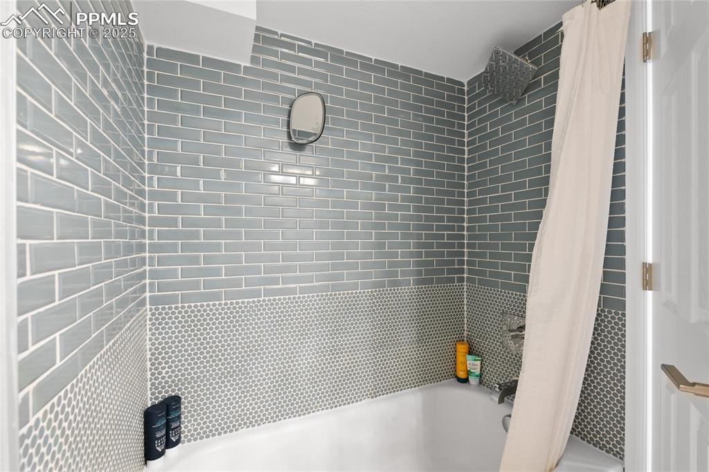 Full bath featuring shower / tub combo