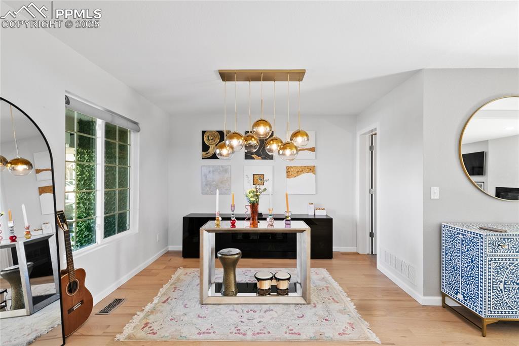 Dining room featuring a chandelier and light wood-style flooring