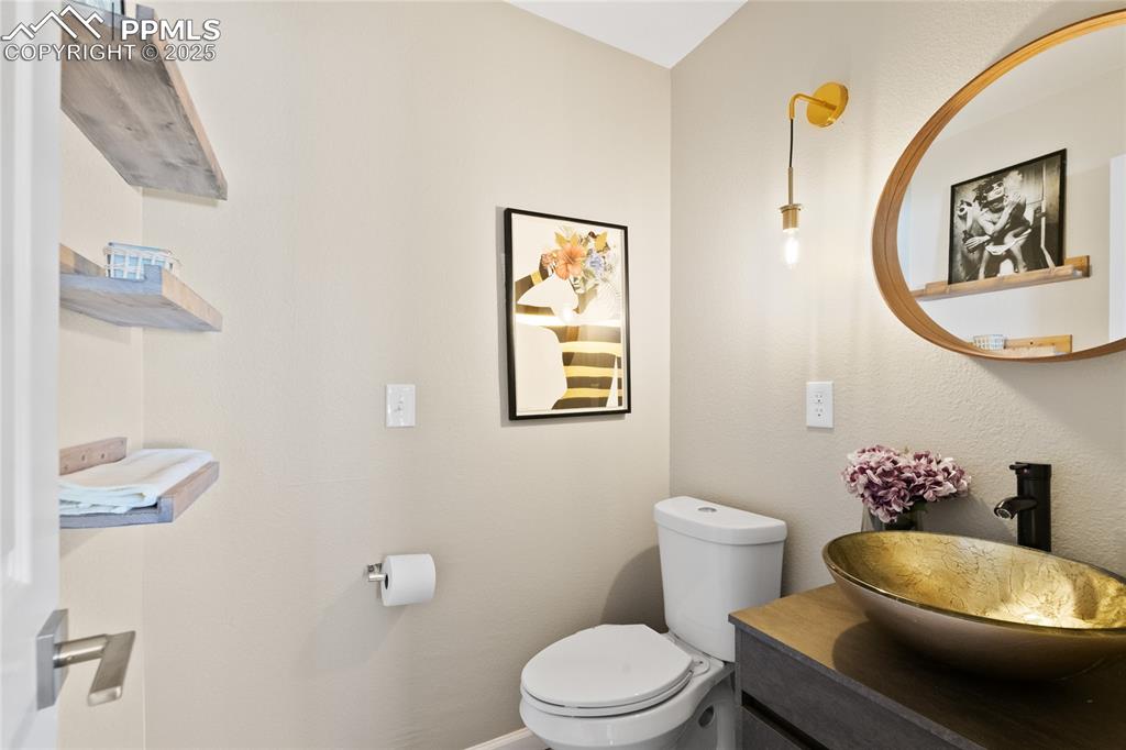 Half bathroom with toilet and vanity