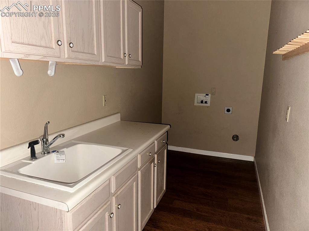 Great mudroom with bank of cabinets with a utility sink