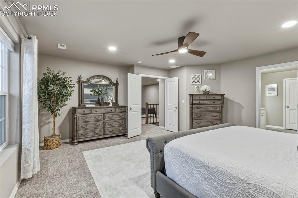 Bedroom with carpet, ceiling fan, and recessed lighting