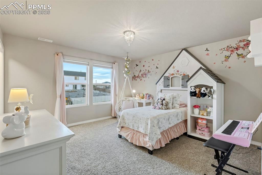 Bedroom featuring light colored carpet and baseboards