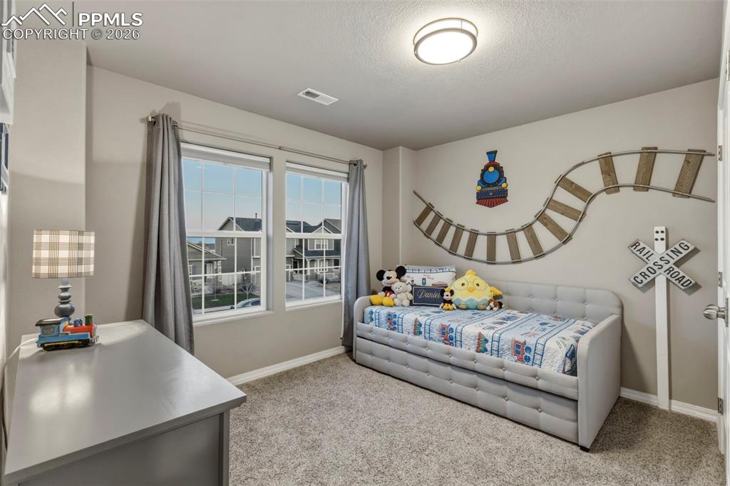 Bedroom with light carpet and baseboards