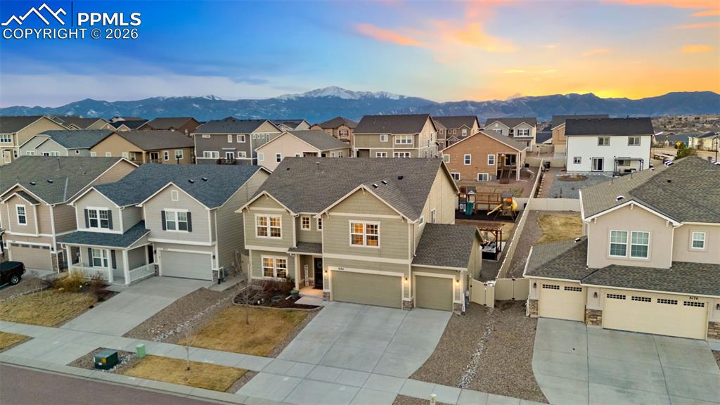 Aerial perspective of suburban area featuring a mountainous background