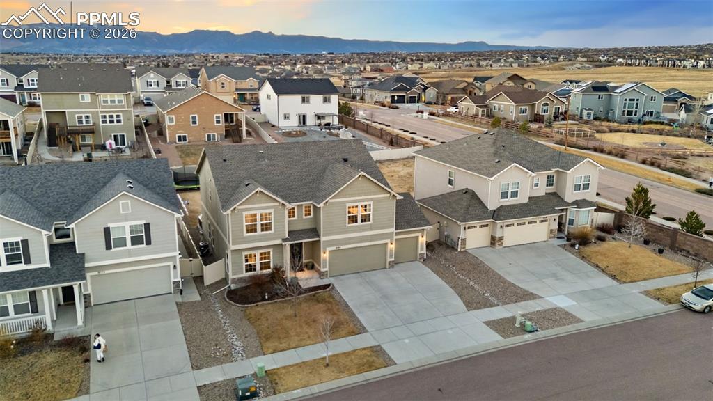 Aerial perspective of suburban area featuring a mountain backdrop