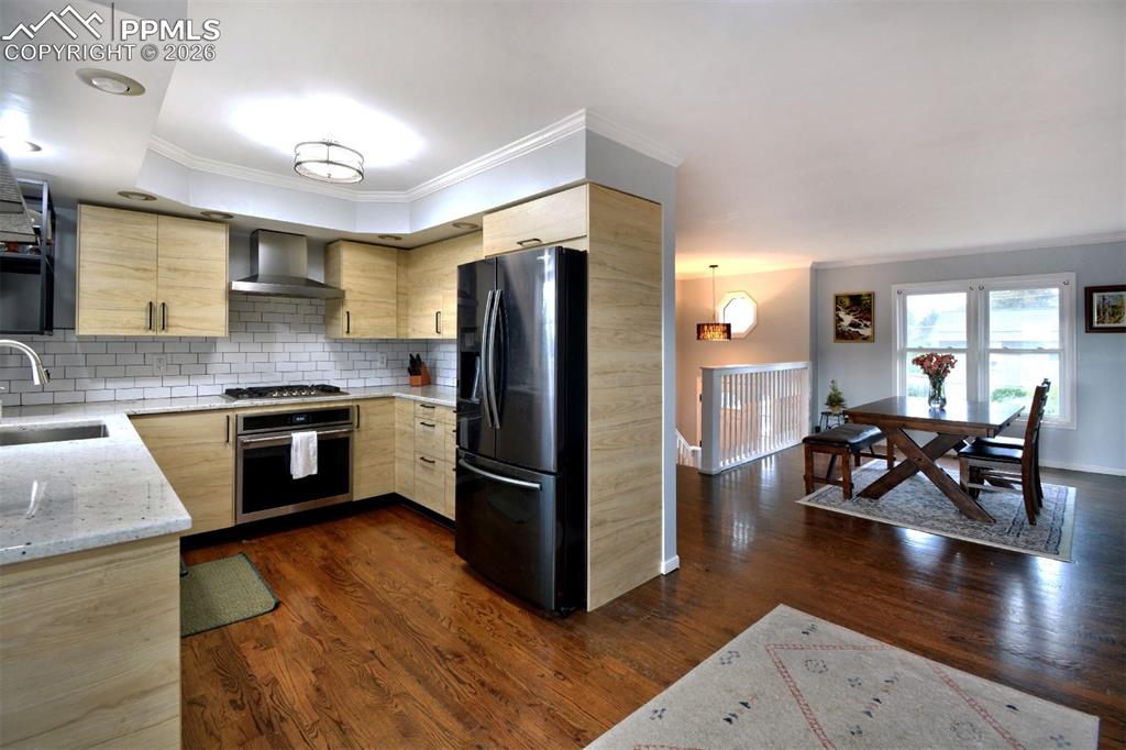 Newly renovated kitchen with wood flooring and SS appliances.