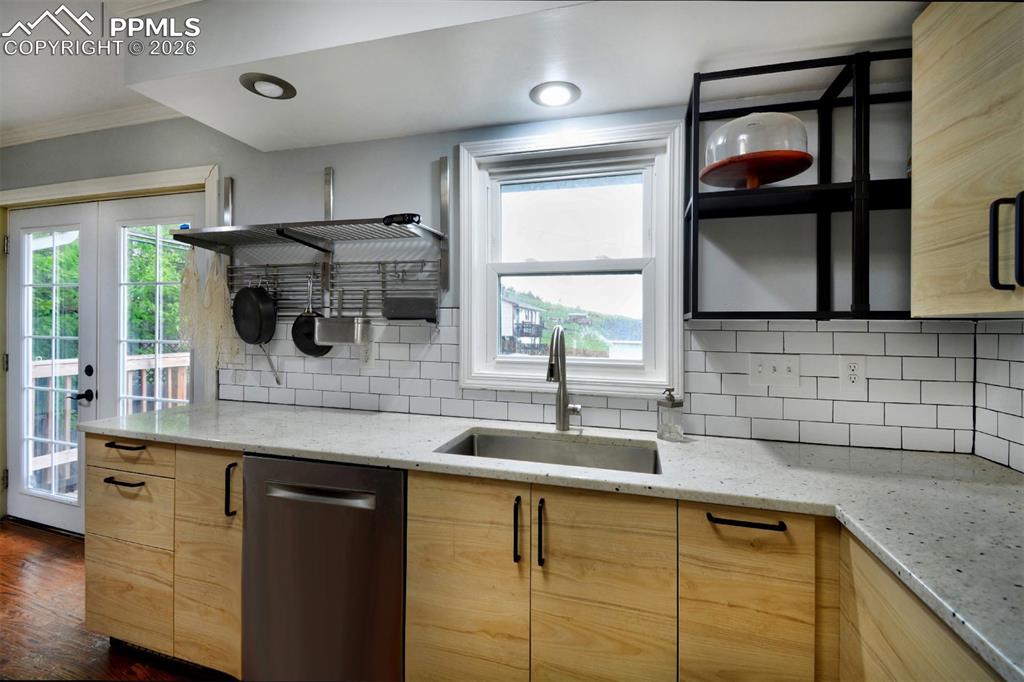 Granite counters, farm sink and open shelving accents.