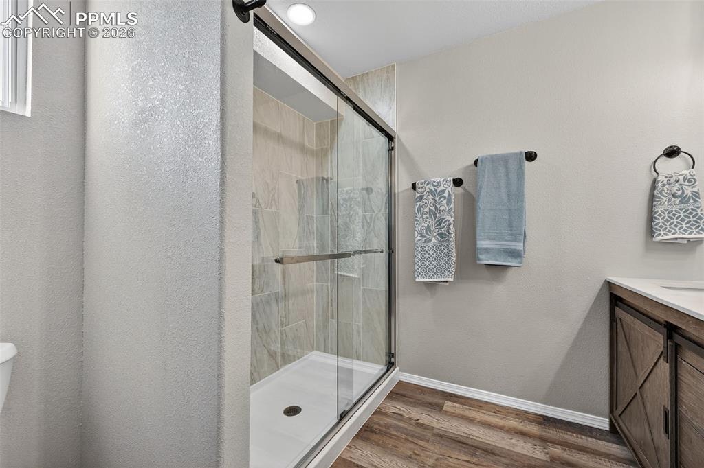 Glass shower doors and custom tile in the large shower. 