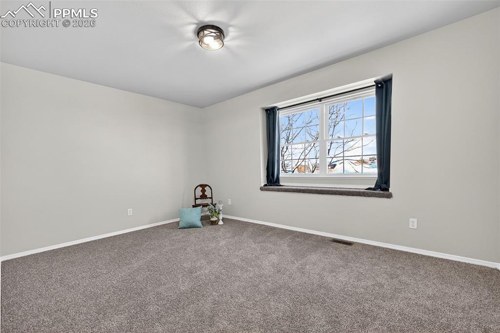 A secondary bedroom on the 2nd floor with a window seat.