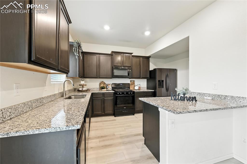 Ample cabinetry and granite countertops for kitchen storage and easy food preparation.
