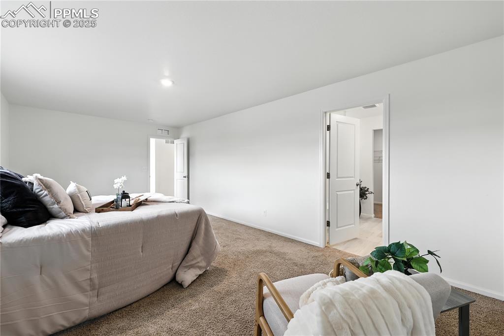 The upper level Primary Suite offers a private sitting area.