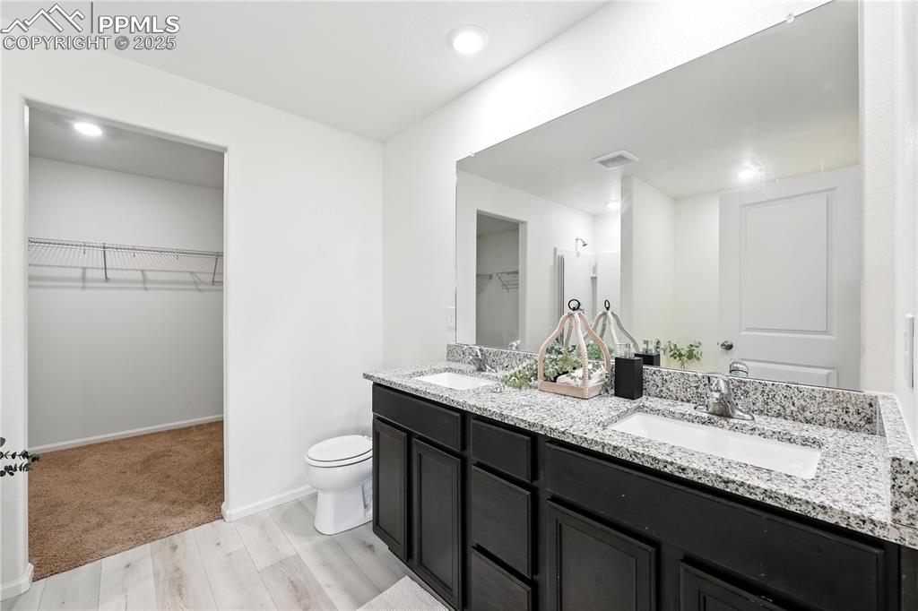5-piece Primary Bathroom with dual sink vanity and walk in closet.