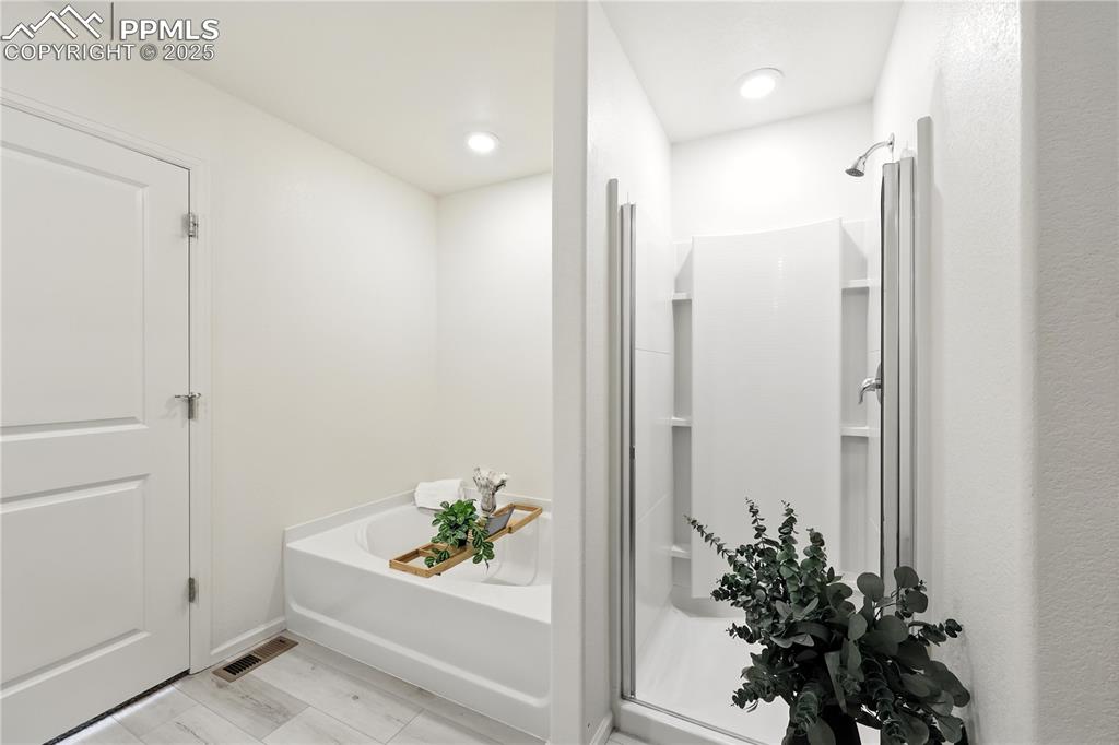 Soaking tub and separate shower in the Primary Bathroom.