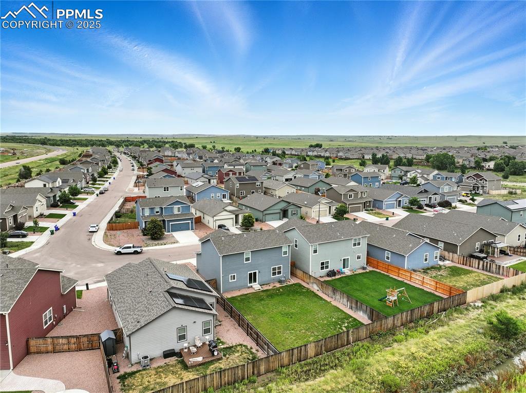 Aerial view of backyard and community.