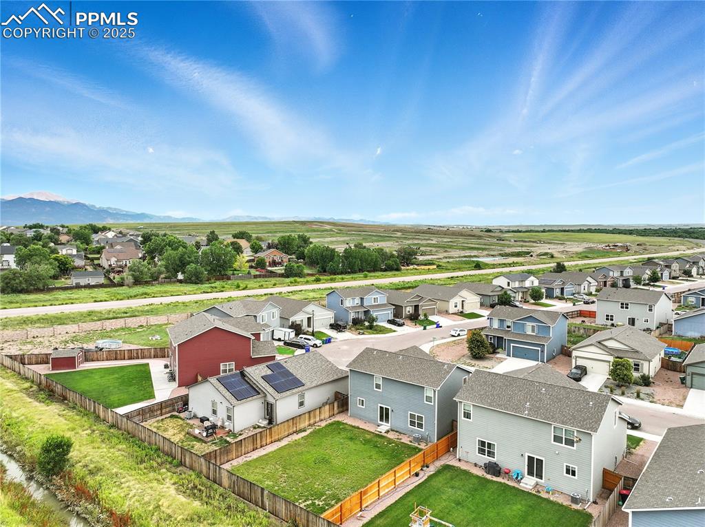 Aerial view of backyard and neighborhood.