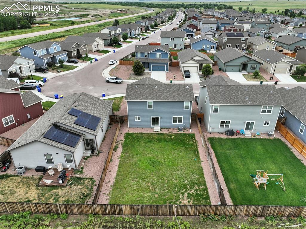 Aerial rear view of home and backyard.