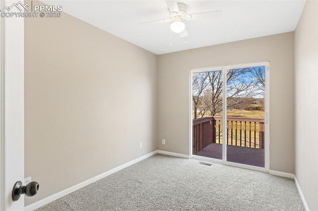 One of three upstairs bedrooms; this one has a walk-out to a composite deck that overlooks the golf course.