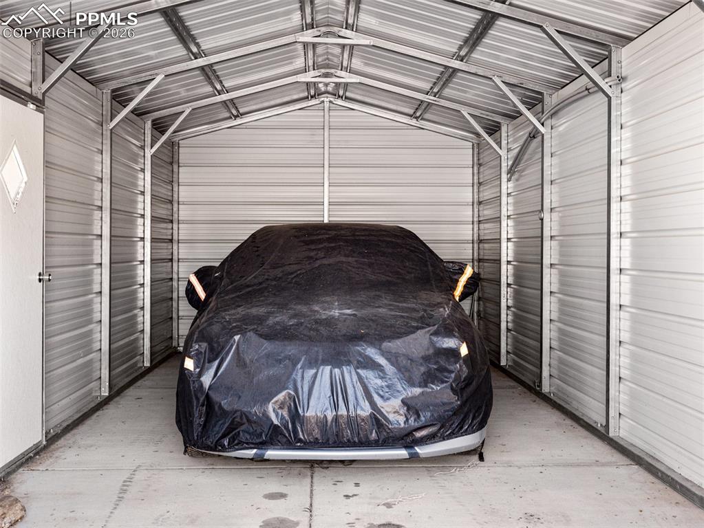 Garage featuring metal wall