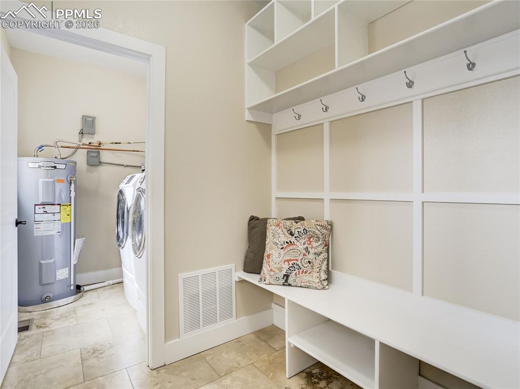 Stylish mud room off of the garage allows for the perfect place for coats, shoes, and all the extras!