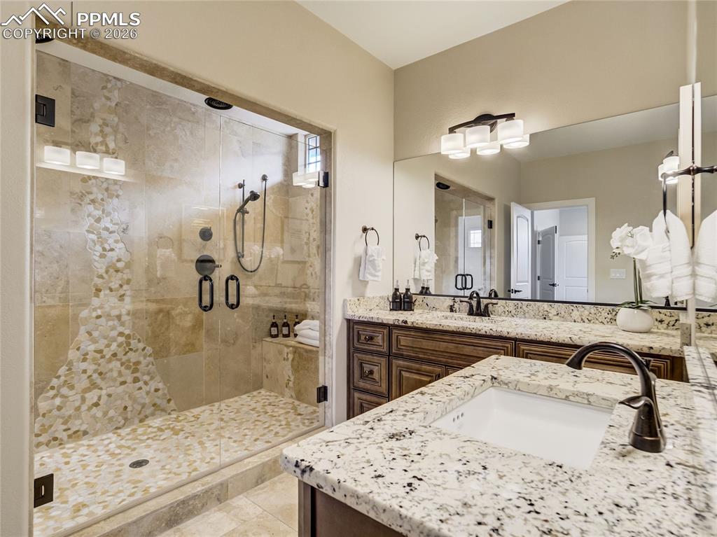 Primary bath features split granite vanities, and a spacious walk-in double-sized shower.