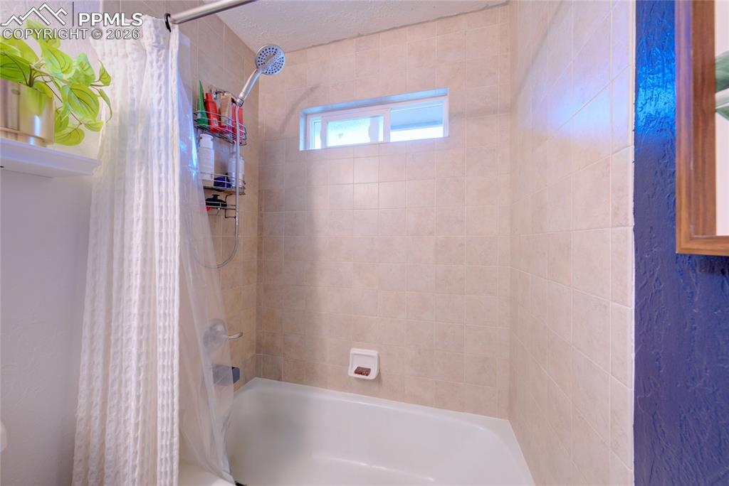 Full bathroom featuring shower / tub combo with curtain