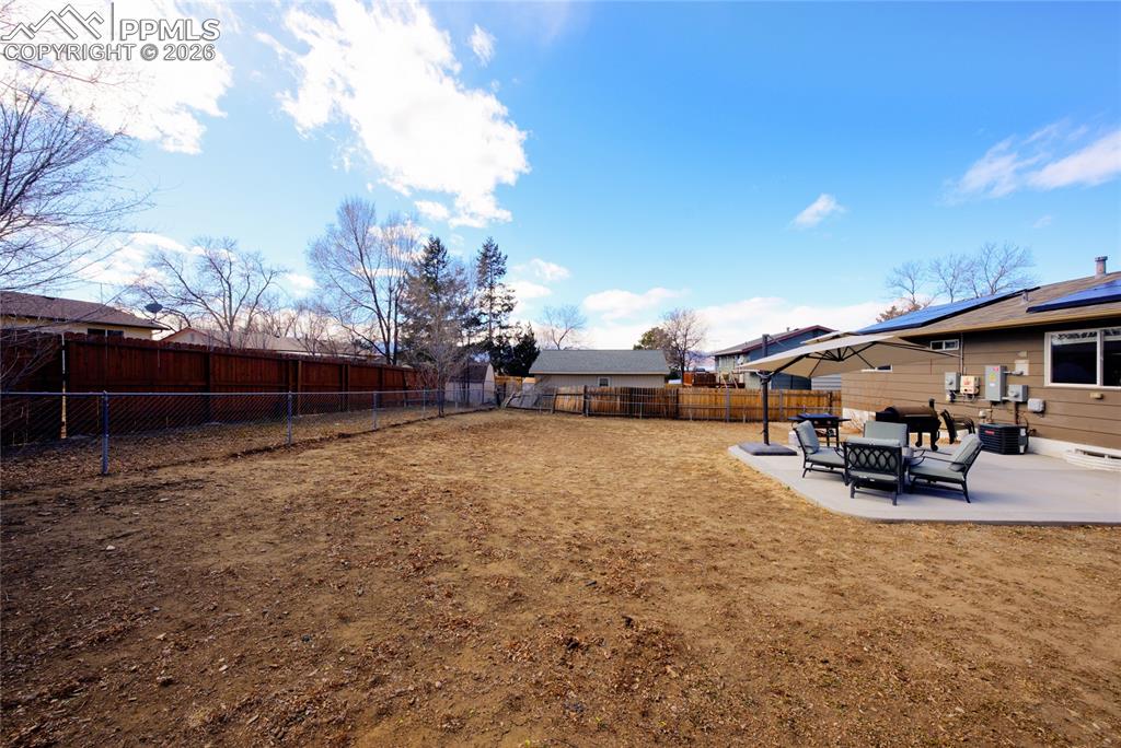 Fenced backyard with a patio