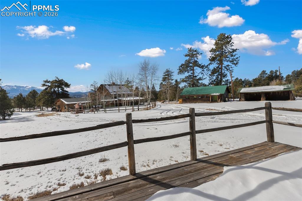 Deck from the 2nd residence overlooking the primary residence, garage and yard