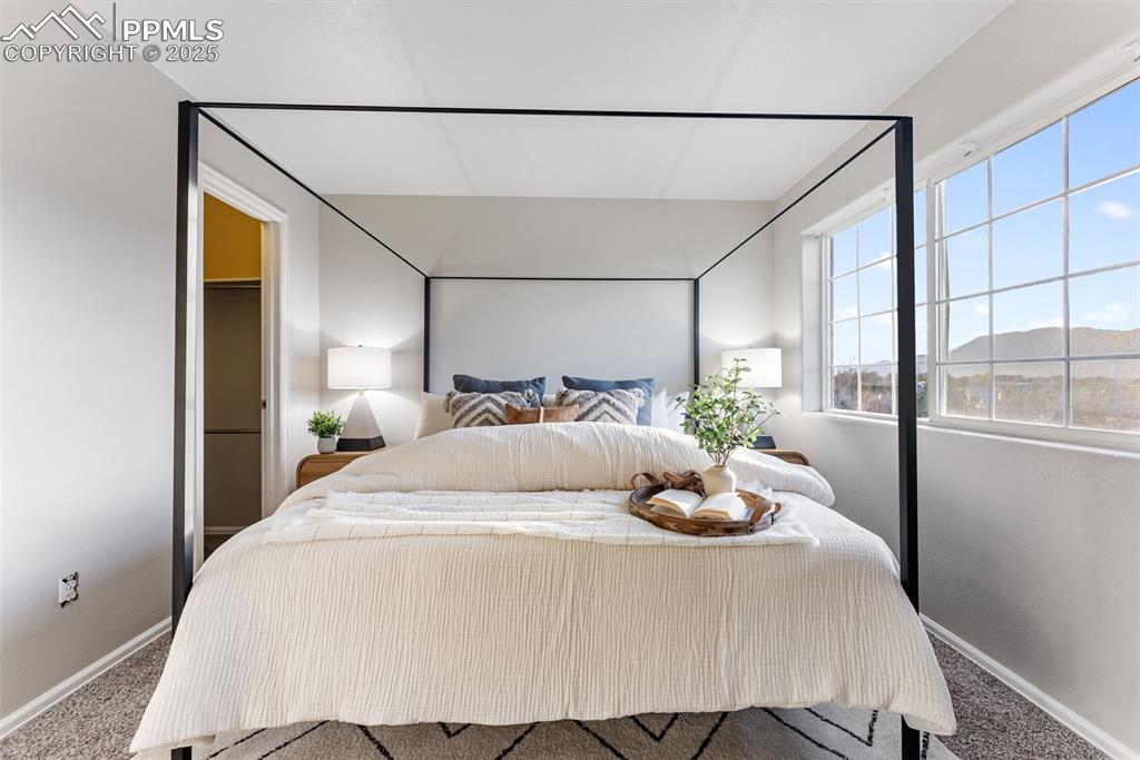 Bedroom with baseboards and carpet flooring