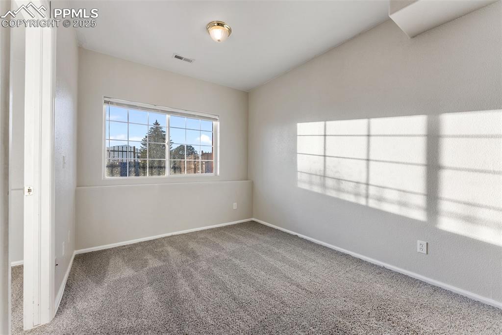 Unfurnished room featuring carpet flooring and baseboards