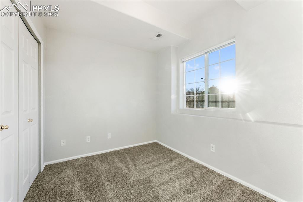 Unfurnished bedroom with a closet and carpet floors