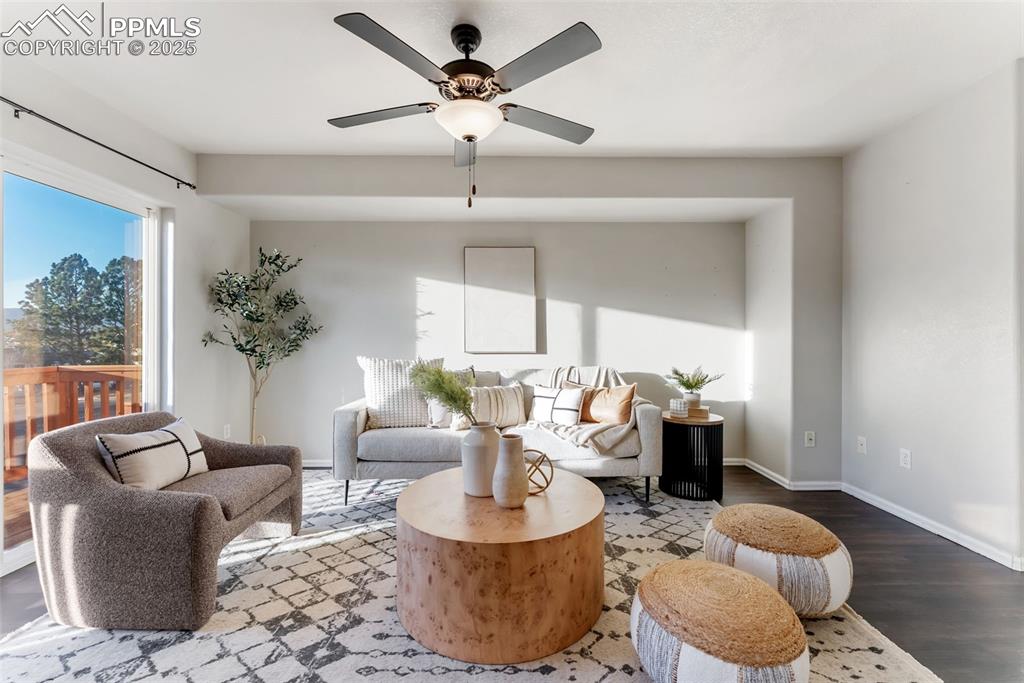 Sitting room with wood finished floors and a ceiling fan