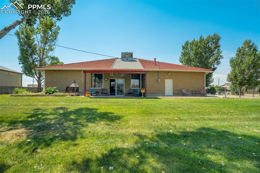Rear view of house featuring a patio area and brick siding