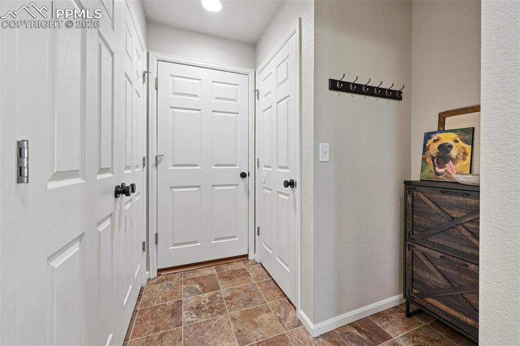Entry from garage, utility closet, and entry to basement