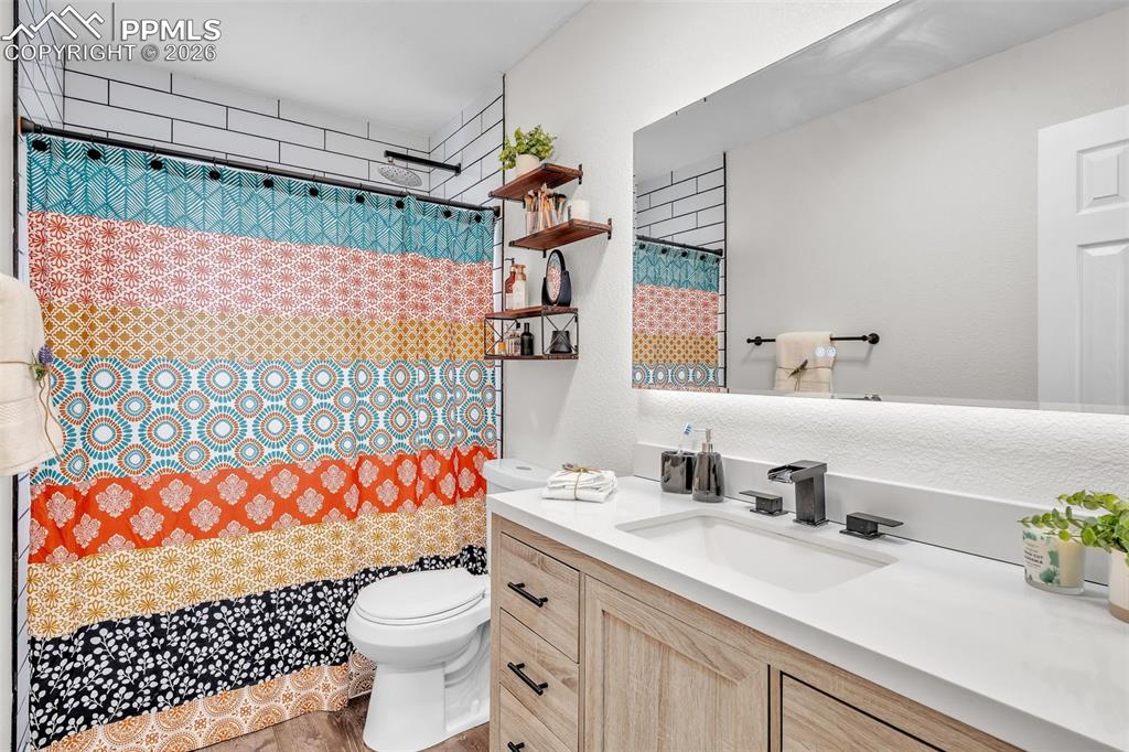 Bathroom with vanity and curtained shower