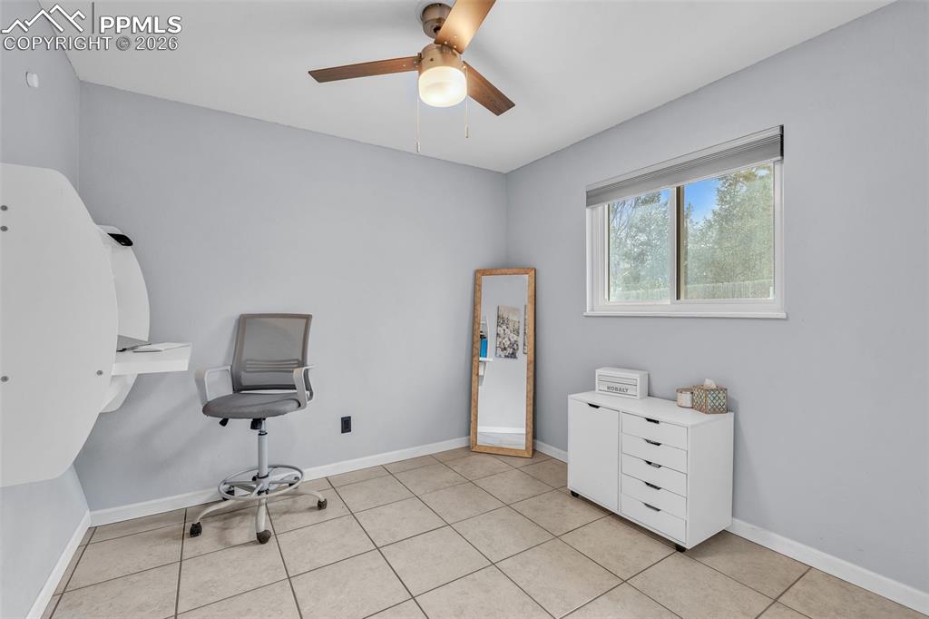 Office featuring ceiling fan and baseboards